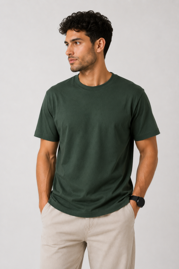 A male model looking to the side showcasing the front fit of our premium lightweight forest green t-shirt.