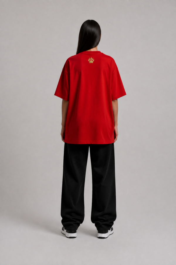TAP Red Oversized Tee – Gold Paw Logo Back (Women's) Back of TAP red oversized tee with gold paw logo on the upper back, female model