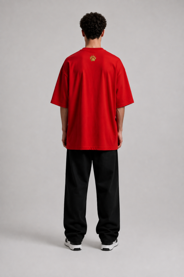 TAP Red Oversized Tee – Gold Paw Logo Back (Men's) Back of TAP red oversized tee with gold paw logo between the shoulders, male model