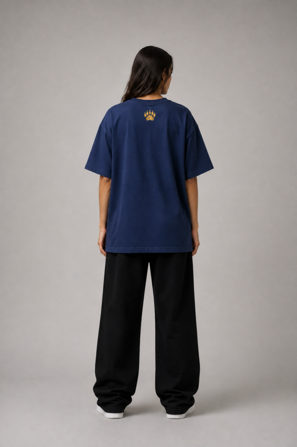 TAP Navy Oversized Tee – Gold Paw Logo Back (Women's) Back of TAP navy oversized tee with gold paw logo on the upper back, female model