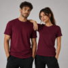 Man and woman wearing burgundy interlock t-shirts with gold bear paw print - Take a Paw Man and woman wearing burgundy interlock t-shirts with gold bear paw print - Take a Paw