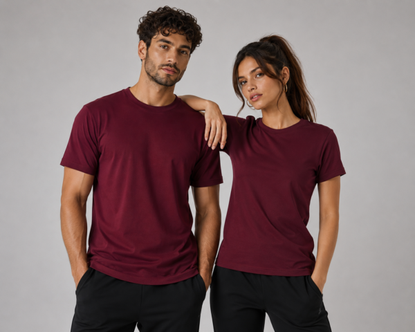 Man and woman wearing burgundy interlock t-shirts with gold bear paw print - Take a Paw Man and woman wearing burgundy interlock t-shirts with gold bear paw print - Take a Paw